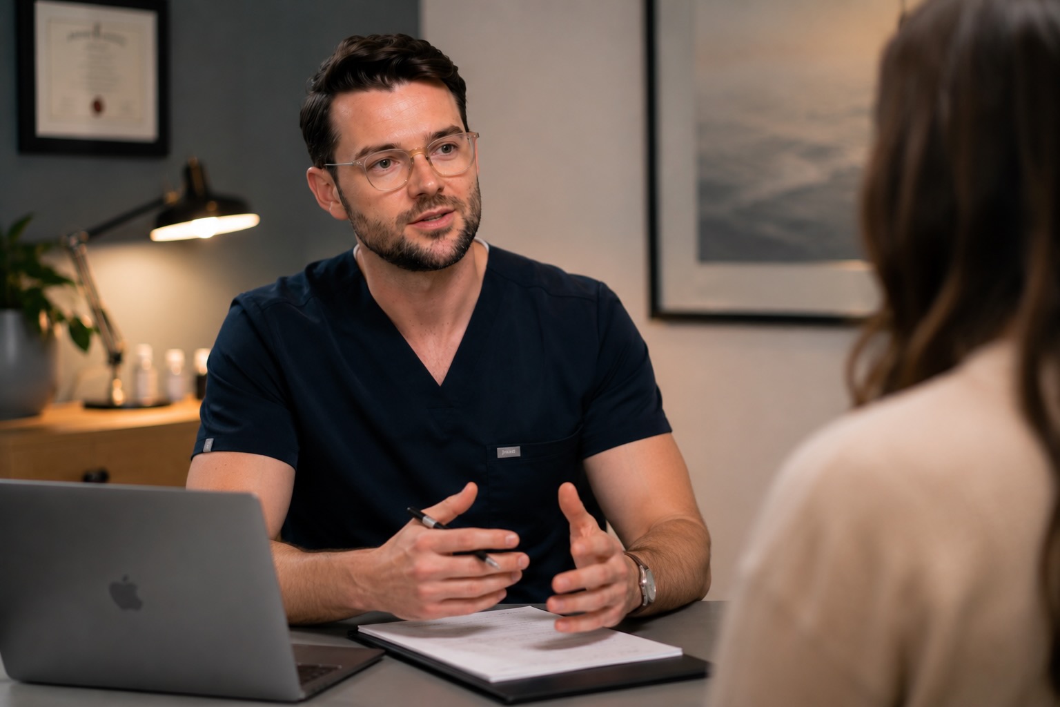 Dr George Collins in consultation with a patient
